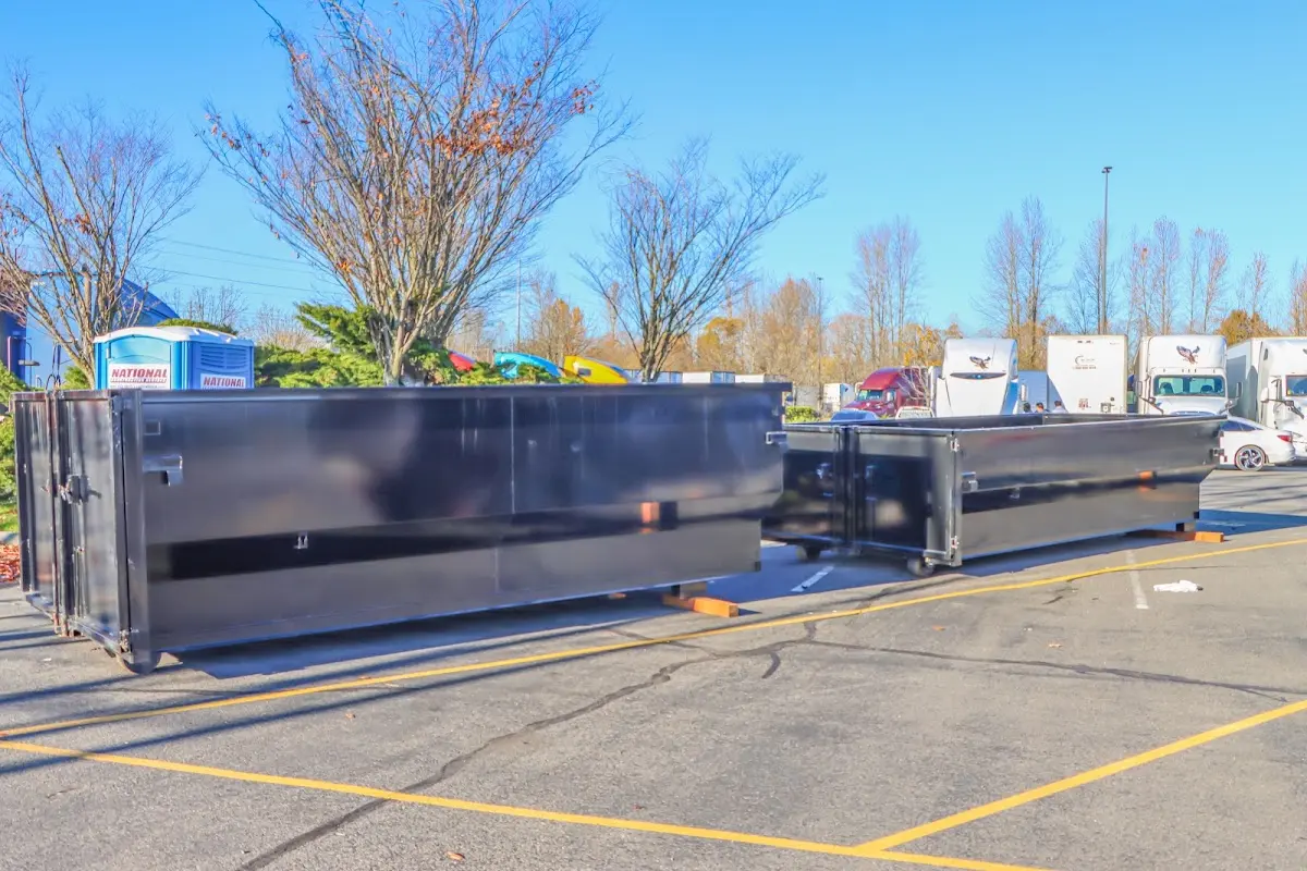 Professional dumpster rental service with roll-off container on residential driveway in Grosse Pointe